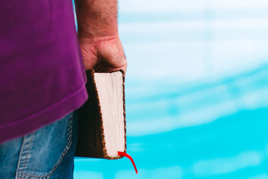 Purple Bible, human hand, people, jeans, midsection