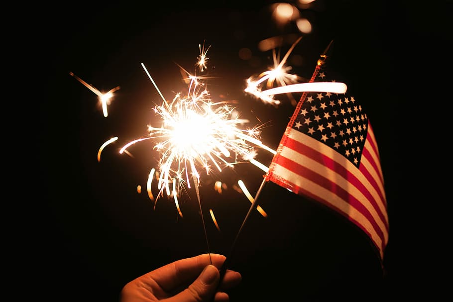 flag, hand, firework  man made object, holding