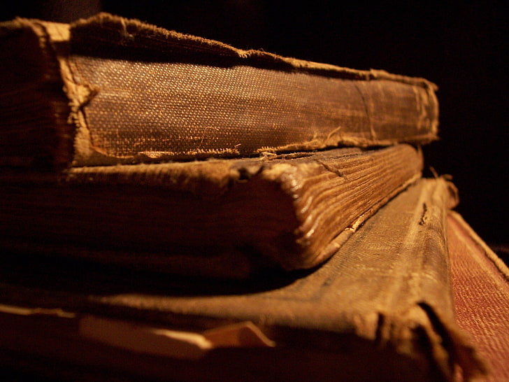 Old Books On Bookshelf, dark, black background, closeup, retro styled