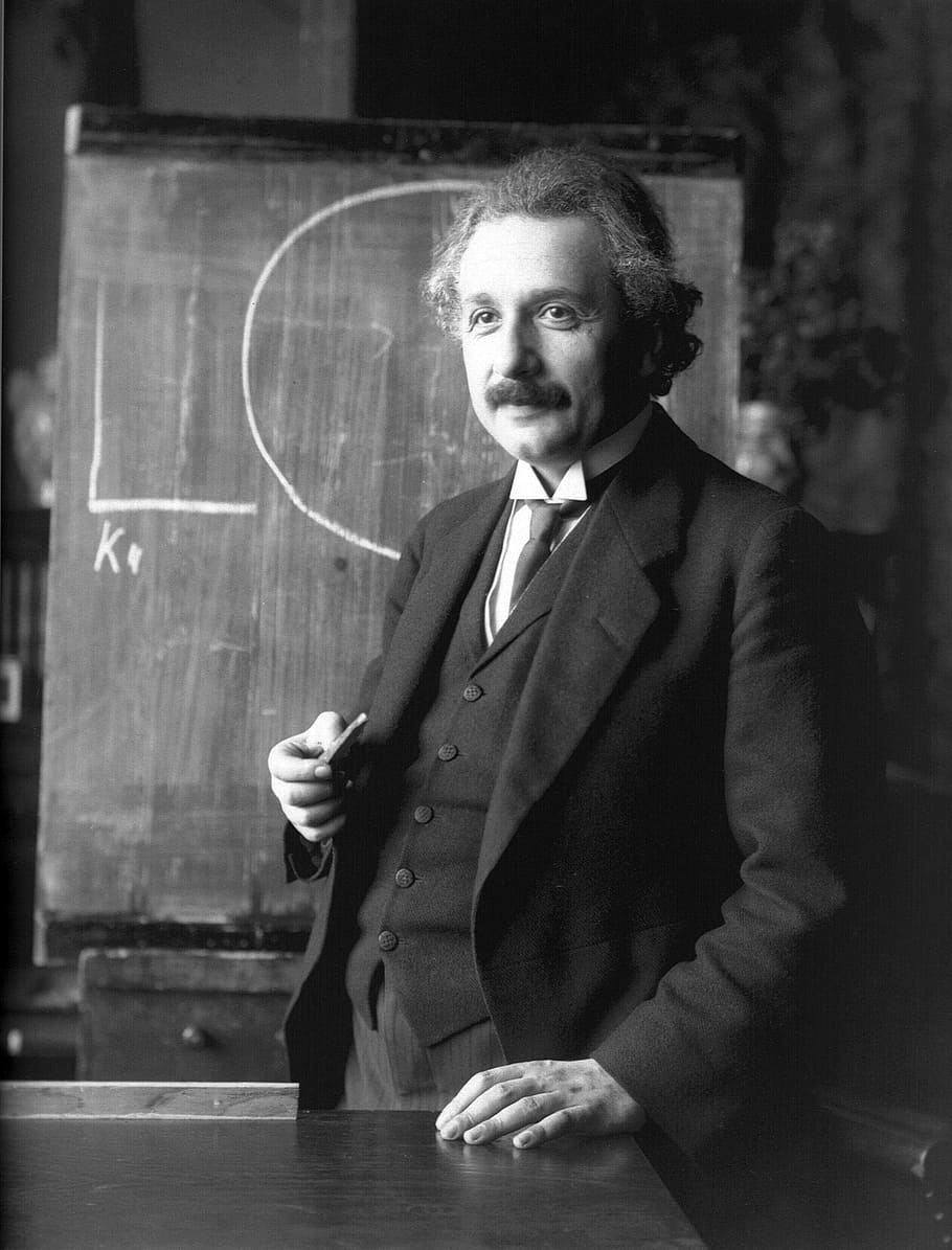 Albert Einstein Biography, waist up, adult, standing, suit Free HD Wallpaper